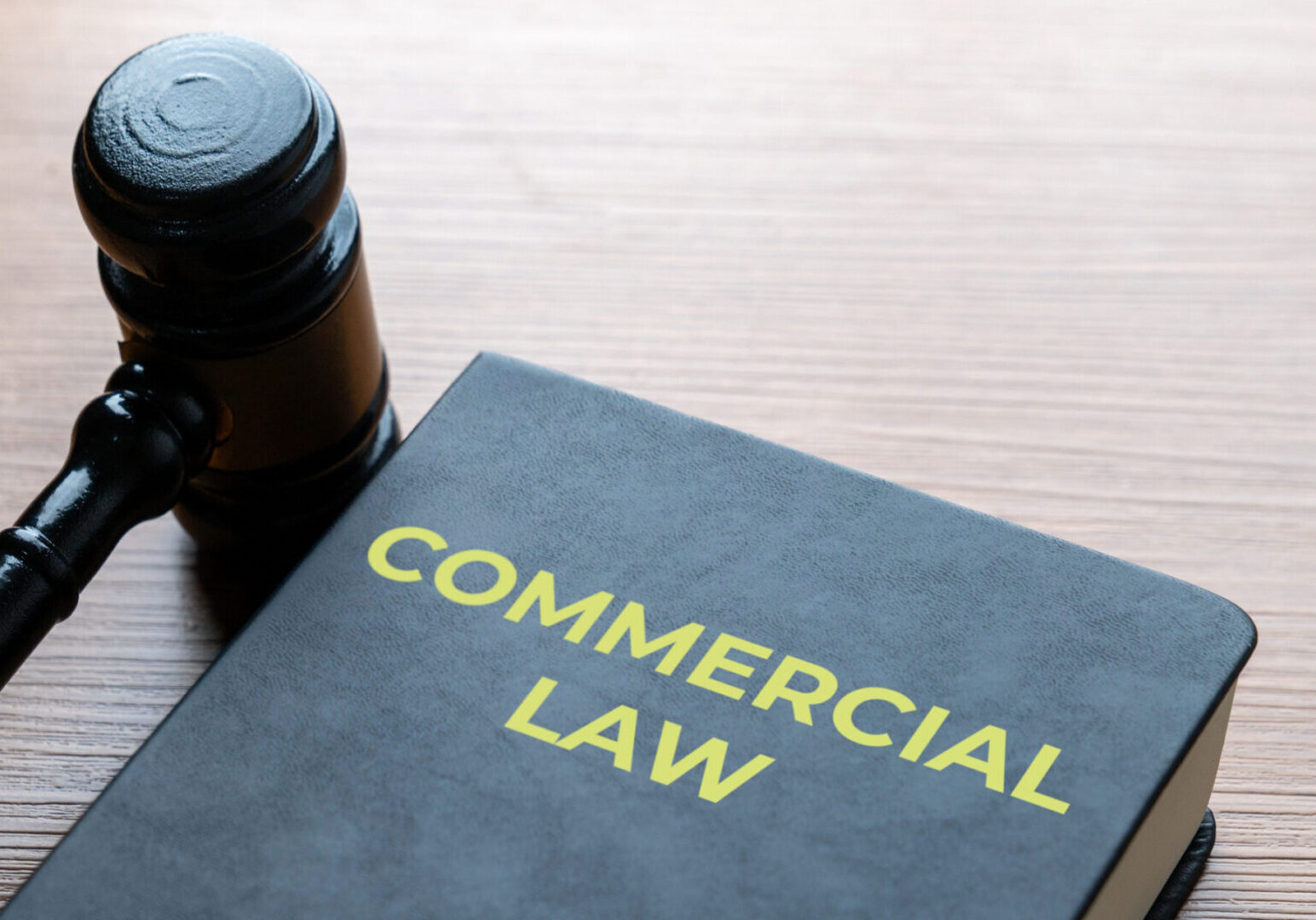 Gavel and commercial law textbook on desk